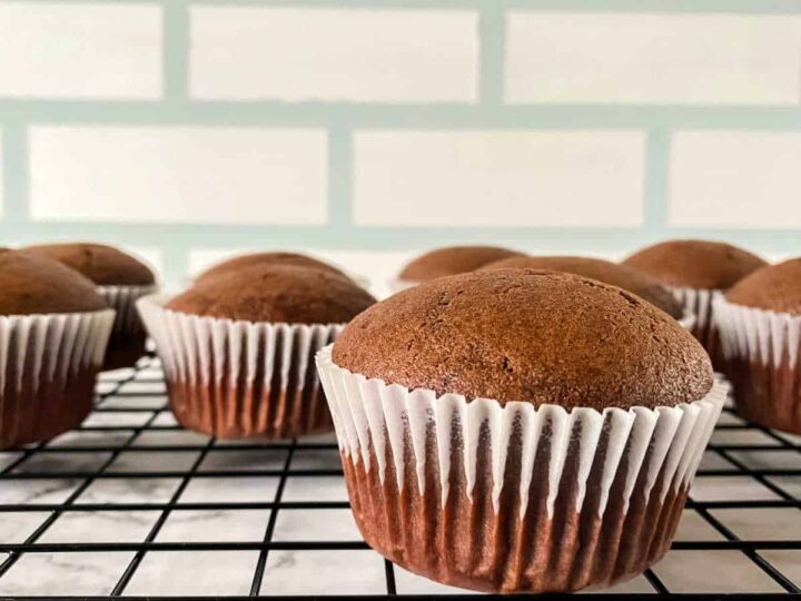 Chocolate cupcakes on a cooling rack.