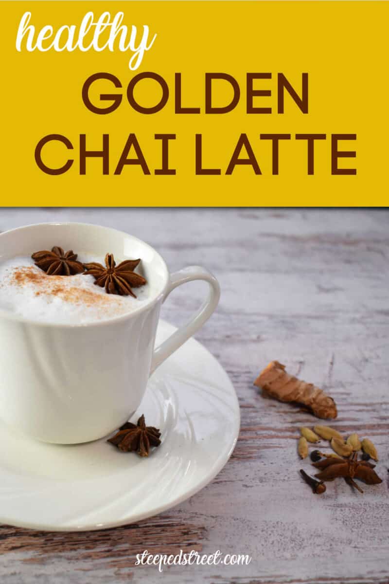 Golden Chai Latte in a white cup on a wooden table with spices scattered around. The text reads healthy golden chai latte. steepedstreet.com