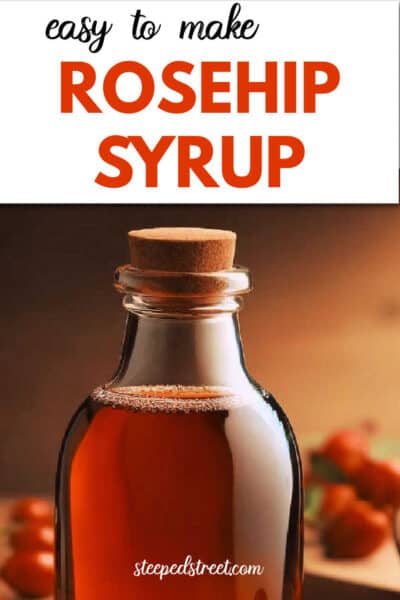 A glass jar containing rosehip syrup surrounded by rosehips. The text reads easy to make rosehip syrup. steepedstreet.com