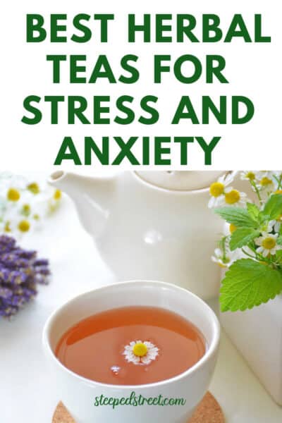 A white tea cup with chamomile tea and a chamomile flower and lavender near by. The text reads best herbal teas for stress and anxiety. steepedstreet.com