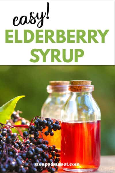 Elderberry syrup in a glass jar surrounded by elderberries. The text reads easy elderberry syrup.