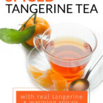 Tangerine tea in a glass cup with a fresh tangerine and tangerine sections. The text reads how to make spiced tangerine tea with real tangerine + warming spices.