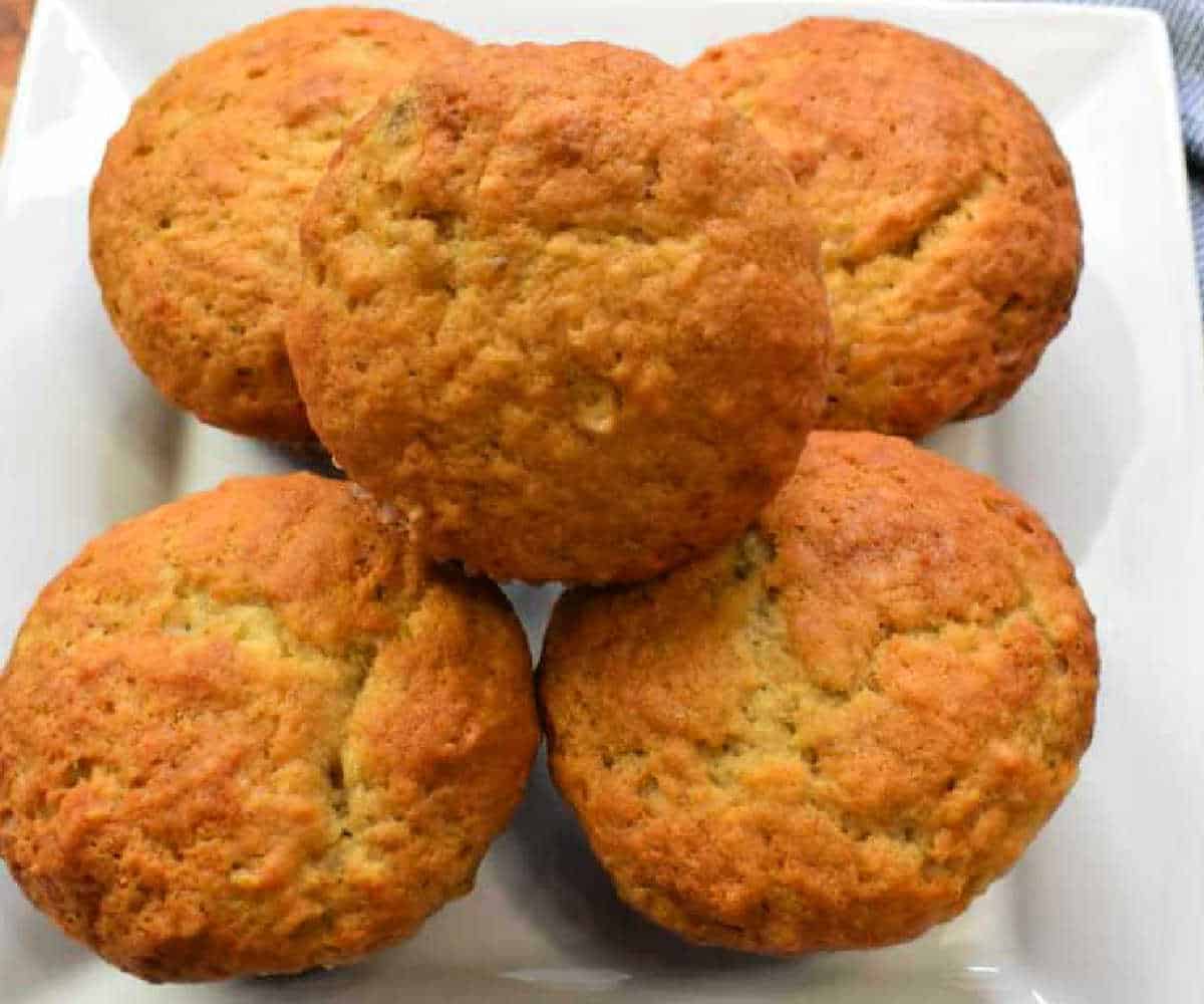Banana muffins on a white plate. The text reads easy banana muffins.