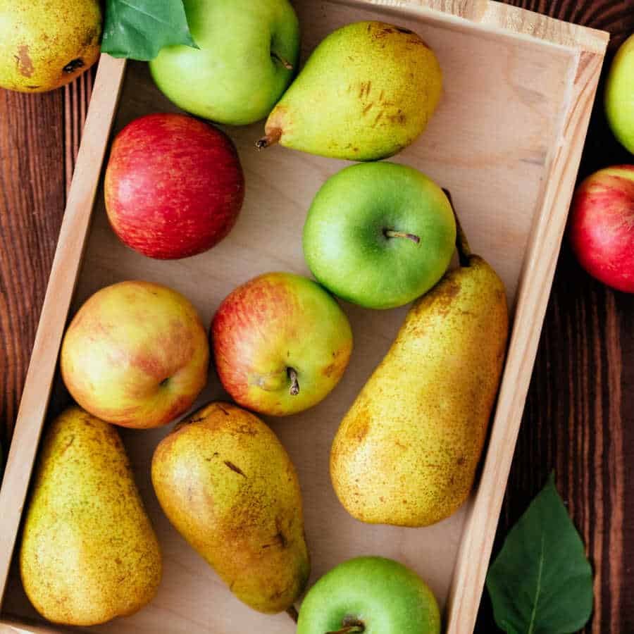 Apples and pears in a wooden crate.