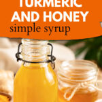 Turmeric and Honey simple syrup in a glass jar on a table with turmeric, ginger and honey. The text reads homemade turmeric and honey simple syrup.